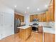 Well-lit kitchen with stainless steel appliances, kitchen island, and hardwood floors at 3515 Mcclure Woods Dr, Duluth, GA 30096