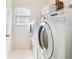 Bright laundry room featuring a white washer and dryer, and a window at 3515 Mcclure Woods Dr, Duluth, GA 30096