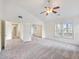Living room with plush carpet, ceiling fan, and large windows with plenty of natural light at 3515 Mcclure Woods Dr, Duluth, GA 30096