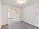 Living room with plush carpet, and view into additional living space with ceiling fan at 3515 Mcclure Woods Dr, Duluth, GA 30096
