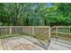 Wooden deck offers outdoor space with wooded backyard views at 511 Ashburton Ave, Decatur, GA 30032