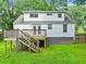 Backyard featuring a wood deck and stairs, white brick, and a level yard at 511 Ashburton Ave, Decatur, GA 30032