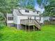Backyard featuring a deck, green lawn, and mature shade trees at 511 Ashburton Ave, Decatur, GA 30032