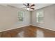 Comfortable bedroom featuring hardwood floors and two windows at 511 Ashburton Ave, Decatur, GA 30032