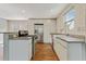 Modern kitchen boasts stainless steel appliances, white cabinetry, and stone countertops at 511 Ashburton Ave, Decatur, GA 30032