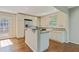 Well-lit kitchen with stainless steel appliances, tile backsplash, island, and hardwood floors at 511 Ashburton Ave, Decatur, GA 30032