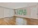 Open living room with beautiful hardwood floors and natural light from the big front window at 511 Ashburton Ave, Decatur, GA 30032