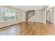 Spacious living room with gleaming hardwood floors, staircase, and large front window at 511 Ashburton Ave, Decatur, GA 30032