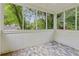 Screened porch with decorative tile flooring and natural views at 511 Ashburton Ave, Decatur, GA 30032