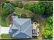 Aerial view of roof, outdoor stone patio with fireplace, deck, and well-manicured yard at 1140 Promontory Drive, Marietta, GA 30062