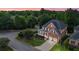 Aerial view of brick home with a two-car garage, manicured lawn and an inviting front porch at 1140 Promontory Drive, Marietta, GA 30062