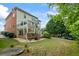 Expansive backyard featuring a multi-tiered deck, lush greenery, and a charming stone retaining wall at 1140 Promontory Drive, Marietta, GA 30062