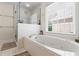 Bright bathroom featuring a soaking tub, glass shower, and heated towel rack at 1140 Promontory Drive, Marietta, GA 30062