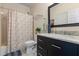 Elegant bathroom featuring marble countertops, dark vanity, and shower/tub combo at 1140 Promontory Drive, Marietta, GA 30062