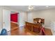 Bright bedroom with a ceiling fan, closet, kid-themed decor, and a view into the adjacent red room through double doors at 1140 Promontory Drive, Marietta, GA 30062