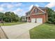 Charming brick home with a well-manicured lawn, two-car garage, and a covered porch, offering classic curb appeal at 1140 Promontory Drive, Marietta, GA 30062
