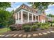 Charming brick home featuring a columned front porch and landscaped yard with stone walkway at 1140 Promontory Drive, Marietta, GA 30062