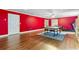 Large game room with hardwood floors, ping pong table, and a treadmill, illuminated by recessed lighting and natural light at 1140 Promontory Drive, Marietta, GA 30062