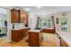 Bright kitchen featuring custom cabinets, hardwood floors, stainless steel appliances, and a cozy window seat at 1140 Promontory Drive, Marietta, GA 30062
