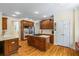 Well-appointed kitchen with an island cooktop, stainless steel appliances, hardwood floors, and custom cabinetry at 1140 Promontory Drive, Marietta, GA 30062