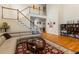 Bright living room featuring hardwood floors, high ceilings, a staircase, and a comfortable sofa at 1140 Promontory Drive, Marietta, GA 30062