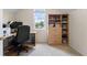 Office space with a desk, rolling chair, and book-filled shelves at 1140 Promontory Drive, Marietta, GA 30062