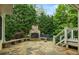 Outdoor fireplace with a stone patio and built in bench seating; perfect for entertaining at 1140 Promontory Drive, Marietta, GA 30062