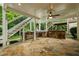 Outdoor kitchen under a covered patio, featuring a stone surround, built-in grill, and ample counter space at 1140 Promontory Drive, Marietta, GA 30062