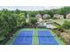 Aerial view of community tennis courts, swimming pool and clubhouse, surrounded by mature trees and upscale homes at 1140 Promontory Drive, Marietta, GA 30062