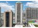 A vibrant cityscape showcasing modern high-rise buildings under a sunny, partly cloudy sky at 1280 W Peachtree Nw St # 2205, Atlanta, GA 30309