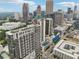 A vibrant cityscape showcasing modern high-rise buildings, tennis court, swimming pools, and lush greenery under a sunny sky at 1280 W Peachtree Nw St # 2205, Atlanta, GA 30309