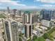 A vibrant cityscape showcasing modern high-rise buildings, swimming pools, and lush greenery under a sunny sky at 1280 W Peachtree Nw St # 2205, Atlanta, GA 30309