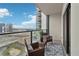 Cozy balcony featuring city views, wicker furniture, and a patterned rug, perfect for relaxation at 1280 W Peachtree Nw St # 2205, Atlanta, GA 30309