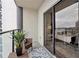 Relaxing outdoor balcony with wicker furniture, plant, and glass railing, offering fresh air at 1280 W Peachtree Nw St # 2205, Atlanta, GA 30309
