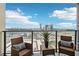 Charming balcony featuring city views, wicker furniture, and a patterned rug, perfect for entertaining at 1280 W Peachtree Nw St # 2205, Atlanta, GA 30309