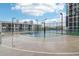 Outdoor basketball court with lighting, surrounded by fence and buildings under a partly cloudy sky at 1280 W Peachtree Nw St # 2205, Atlanta, GA 30309