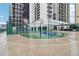 Outdoor basketball court surrounded by high-rise buildings with nearby seating and tables under a bright sky at 1280 W Peachtree Nw St # 2205, Atlanta, GA 30309