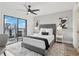 Well-lit bedroom featuring a ceiling fan, modern decor, and balcony access at 1280 W Peachtree Nw St # 2205, Atlanta, GA 30309