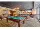 Elegant billiard room featuring two billiard tables, pendant lighting, and comfortable seating at 1280 W Peachtree Nw St # 2205, Atlanta, GA 30309