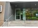 Close up of a modern entrance with metal railing and large windows at 1280 W Peachtree Nw St # 2205, Atlanta, GA 30309