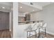 Modern kitchen with gray cabinets and a breakfast bar with two chairs near the entryway at 1280 W Peachtree Nw St # 2205, Atlanta, GA 30309