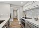 Well-lit kitchen with stainless steel appliances and access to a hallway leading to additional rooms at 1280 W Peachtree Nw St # 2205, Atlanta, GA 30309