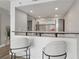 Modern kitchen and bar featuring quartz countertops, stainless steel appliances, and stylish barstools at 1280 W Peachtree Nw St # 2205, Atlanta, GA 30309
