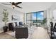Bright living room featuring a ceiling fan, a large window with a view, and modern decor at 1280 W Peachtree Nw St # 2205, Atlanta, GA 30309