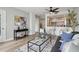 Cozy living room featuring a gray accent chair, an open layout to the kitchen, and a ceiling fan at 1280 W Peachtree Nw St # 2205, Atlanta, GA 30309