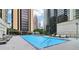 Beautiful outdoor pool with lounge chairs surrounded by luxury high rise buildings in a downtown setting at 1280 W Peachtree Nw St # 2205, Atlanta, GA 30309