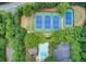 Aerial view of a community pool, spa, and tennis courts surrounded by lush trees at 13067 Overlook Pass, Roswell, GA 30075
