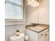 Well-lit bathroom with granite counters, vanity, and toilet for everyday convenience at 13067 Overlook Pass, Roswell, GA 30075