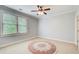 Bright bedroom with a large window, ceiling fan, carpet, and neutral walls at 13067 Overlook Pass, Roswell, GA 30075