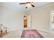 Neutral bedroom with a ceiling fan, carpet, and trim, offering a simple aesthetic at 13067 Overlook Pass, Roswell, GA 30075